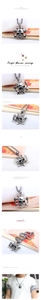 Detailed punk skull and crossbones anchor pendant with a square link chain on a male model