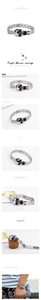 Macro view of silver skull bracelet showing chunky metal links and a toggle clasp detail