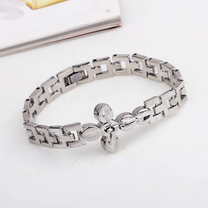 Silver industrial style metal bracelet featuring a hollow cross design on a white surface