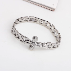 Silver metal cross bracelet with hollow geometric links and embossed angel charm