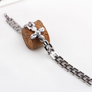 Silver metal cross pendant bracelet with rectangular hollow links on white background