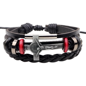 Detail of multi-layer leather bracelet with silver cross and red wooden beads