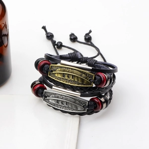 Vintage geflochtenes Lederarmband Set mit Bronze Federanhänger und roten Perlen