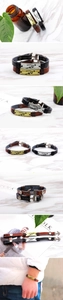 Detail of vintage leather bracelets with engraved Cupid arrow metal plate for couples