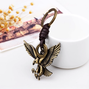 Classic eagle wing metal keychain with vintage bronze finish and brown leather strap