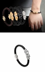 Detail of men's leather braided bracelet with double skull magnetic clasp in various colors