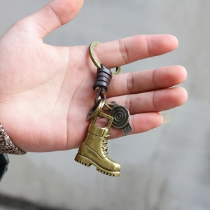 Vintage bronze alloy work boot keychain with woven leather strap and metal tag