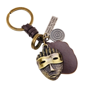Vintage bronze mask keychain with woven leather strap and engraved metal charm accessory