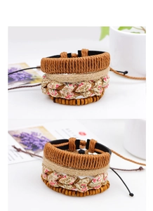 Detailed macro view of bohemian multi-layer woven bracelets with floral fabric and wood beads