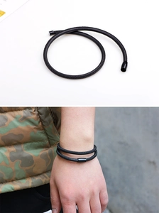 Detail eines mehrlagig geflochtenen Schafsleder-Armbands mit schwarzem Magnetverschluss