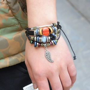 Multilayer braided leather bracelet with ethnic beads and metal feather pendant charms
