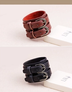 Detail of genuine cowhide double-buckle leather wristbands in brown and black