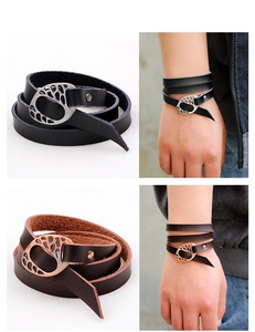 Detail of multi-layer leather wrap bracelet with hollow oval metal buckle in retro punk style