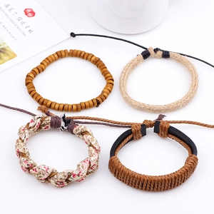 Set of four bohemian braided leather bracelets with floral fabric and wooden beads