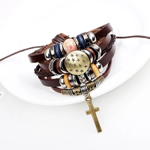 Multilayer leather cross bracelet with star charm and vintage beads on white porcelain