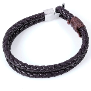 Detail view of woven brown leather bracelet with silver stainless steel magnetic clasp