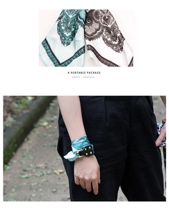 Detail of paisley silk scarf worn as a wristlet with leather strap and tiffany green print