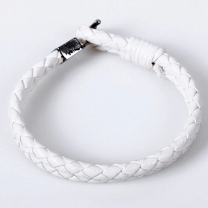 Close-up of white braided leather bracelet featuring a polished silver metal clasp