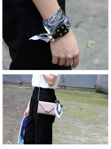 Close-up of paisley silk scarf tied with a black leather gold buckle strap on a pink bag