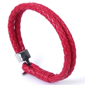 Detailed view of red woven leather bracelet with a polished silver-tone metal clasp