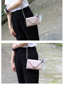 Pink envelope crossbody bag with metal V-clasp and black-white polka dot scarf detail
