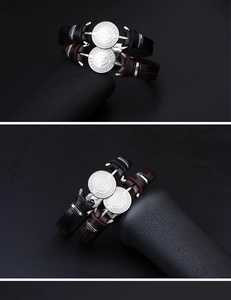Detail of nautical leather bracelets featuring silver anchor charms in black and brown colors