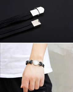 Detail of nautical anchor leather bracelet with silver clasp and model wrist shot