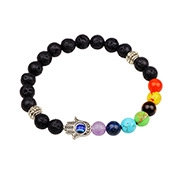 Detail showing the Hamsa Hand and Evil Eye charm on a 7 Chakra lava stone bracelet
