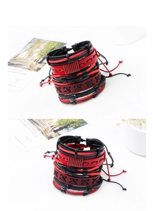 Close-up of multilayer braided leather bracelets in black and red with cross-stitch details