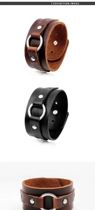 Close-up of retro punk wide leather bracelet with metal rings and silver rivets detail