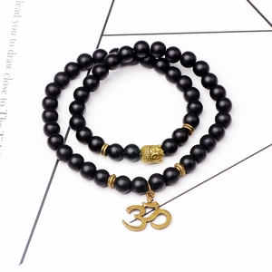 Bracelet ethnique double couche en perles noires mates avec tête de bouddha dorée