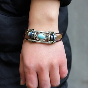 Vintage multilayer leather bracelet with turquoise stone and ethnic bronze beads on wrist