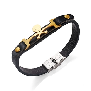 Punk leather bracelet with golden skull motif and stainless steel fold-over clasp