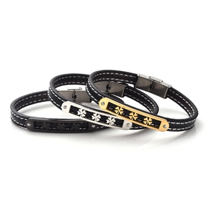 Detailed view of stainless steel four-leaf clover charms on black stitched leather bracelets