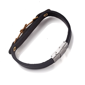 Detail of men's black leather punk bracelet with silver buckle and vintage gear charms