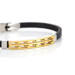 Detail of men's leather bracelet featuring a two-tone gold and silver geometric metal plate