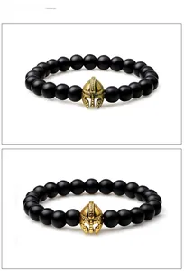 Macro detail of Spartan helmet bead and matte black stones on elastic bracelet