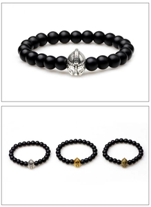 Spartan helmet charms on matte black beaded elastic bracelets in gold, silver, and bronze