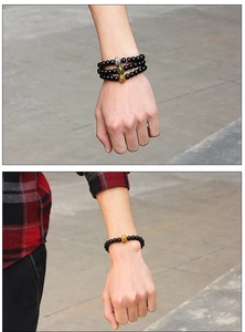 Spartan helmet charms on matte black beaded stretch bracelets in gold, silver, and bronze