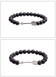 Détail du bracelet en pierre de lave et agate mate avec pendentif flèche serti