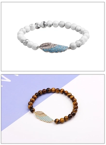 Detail of beaded bracelets featuring tiger eye stones and micro-set angel wing charms