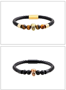 Detail of leather bracelets with tiger eye beads and crystal-set skull magnetic clasps