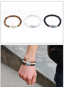 Detailed set of three bead bracelets with tiger eye, white turquoise, and winged charms