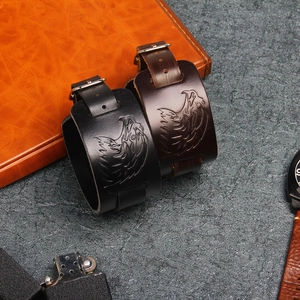 Detail of vintage leather bracelets with eagle emblem and adjustable buckles in punk style