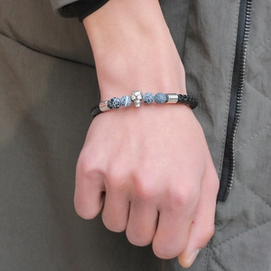Men's punk leather bracelet with silver skull charm and tiger eye beads on wrist