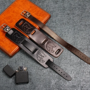 Detail of vintage eagle embossed leather bracelet with metallic buckle in black and brown