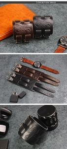 Macro detail of scorpion embossed leather wristband with adjustable metal buckles