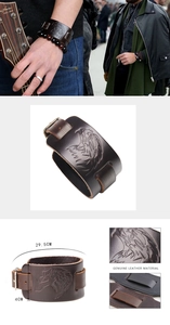 Detail view of vintage brown leather wristband with eagle embossing and buckle strap