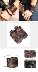 Detail of vintage brown leather wristband with bear paw embossing and double buckle straps