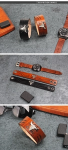 Macro shot of punk style wide leather bracelet with metal bull head and tribal pattern